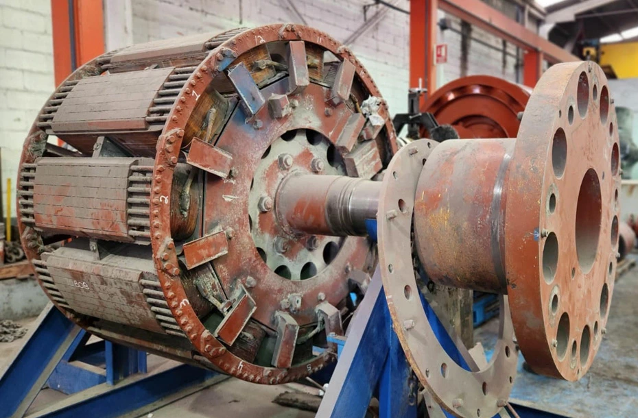 Detalle técnico de rotor de polos salientes durante proceso de inspección y mantenimiento de generador eléctrico industrial.
